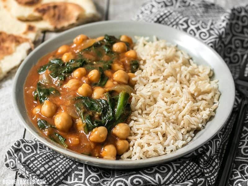Front view of a bowl of Curried Chickpeas with Spinach and brown basmati rice.