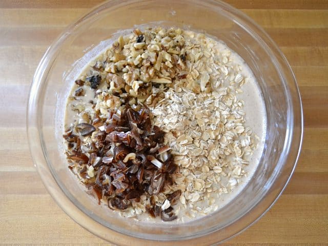 Oats, Walnuts and Dates added to wet ingredients in mixing bowl 