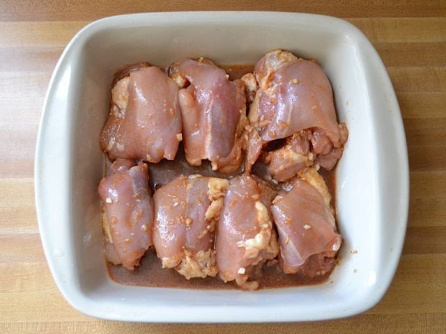 Marinated chicken thighs in baking pan ready to bake
