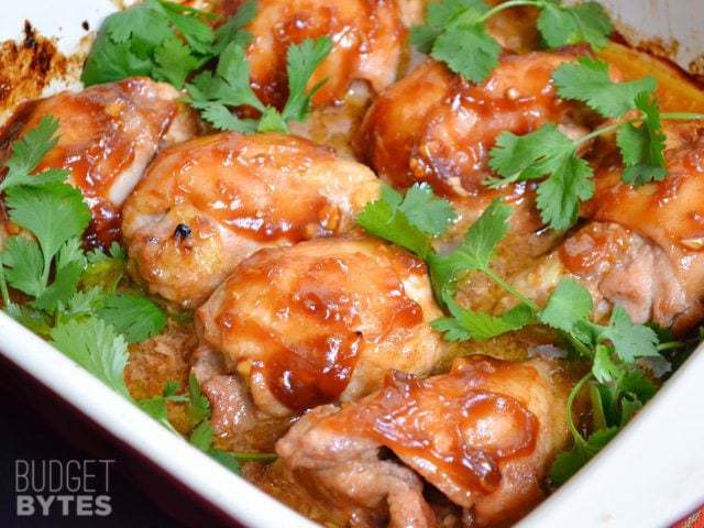 Honey Sriracha Chicken Thighs in baking pan 
