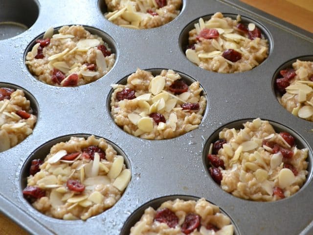 Toppings added to oatmeal mixture in muffin tin 