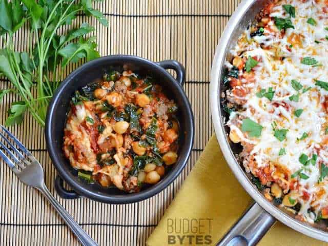 Kale & Sausage Skillet with a small portion taken out and placed in bowl 