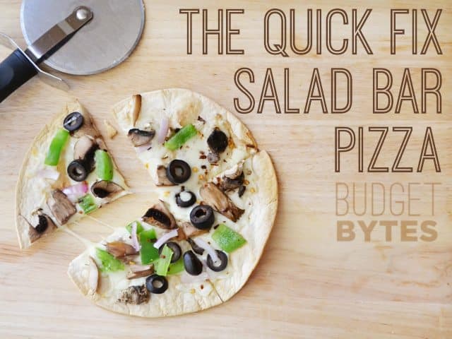 top view of Quick Fix Salad Bar Pizza with pizza cutter 