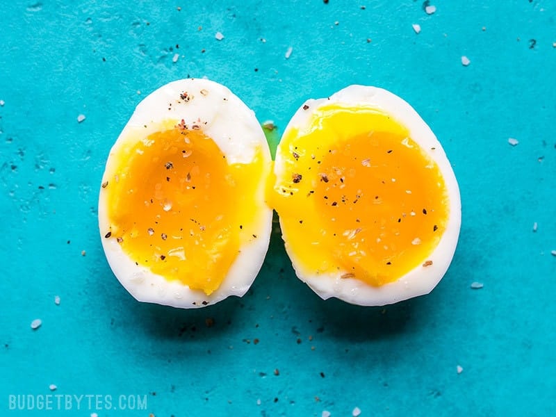 A perfectly cooked soft boiled egg cut open to reveal the silky yolk.
