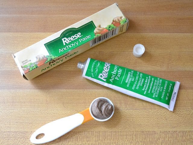 Anchovy Paste tube with measuring spoon next to it 