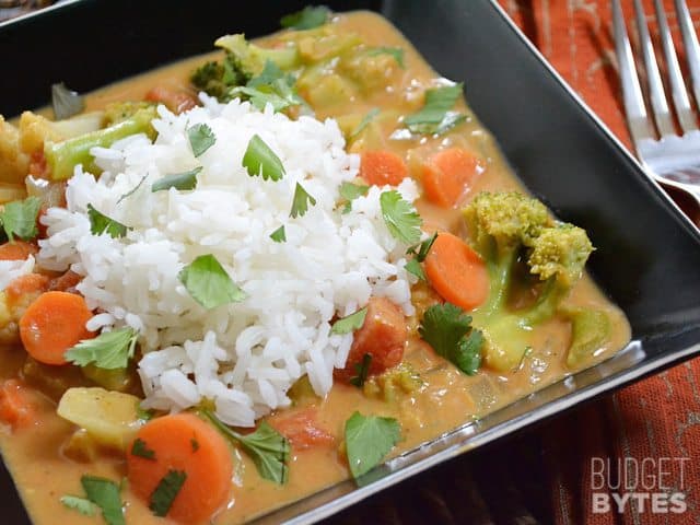Top view of a bowl of Coconut Vegetable Curry with a fork on the side 