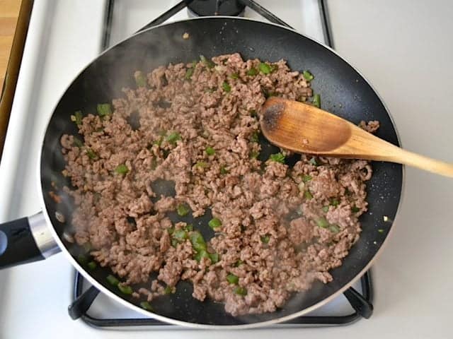 Ground beef added to jalapeño and garlic in skillet and browned 