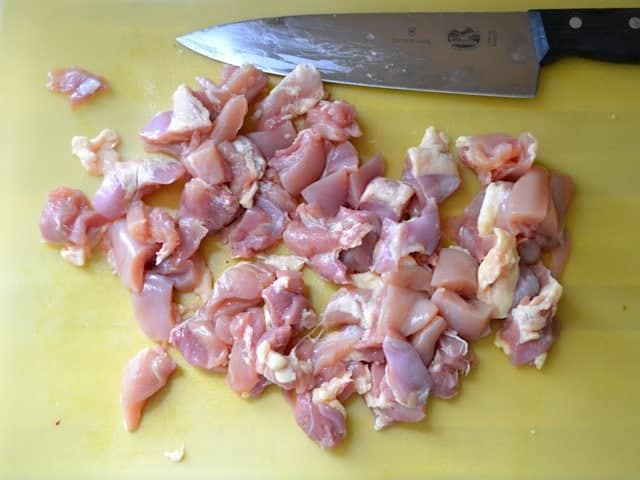 Chopped Chicken thighs with knife 