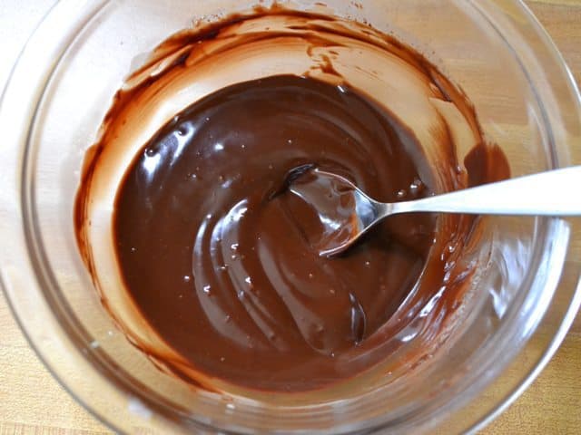 Mixed ganache in mixing bowl with spoon 