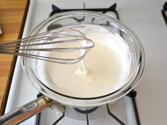 Whisking marshmallow  mixture in double boiler on stove top 