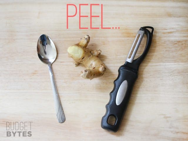 Piece of ginger with peeler and spoon 