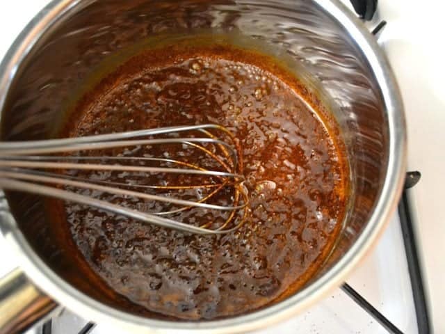 Enchilada Sauce ingredients in pot and whisked together with whisk 