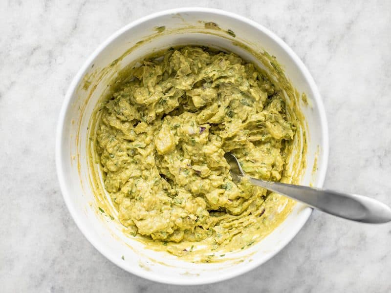 Mashed ingredients in mixing bowl with spoon