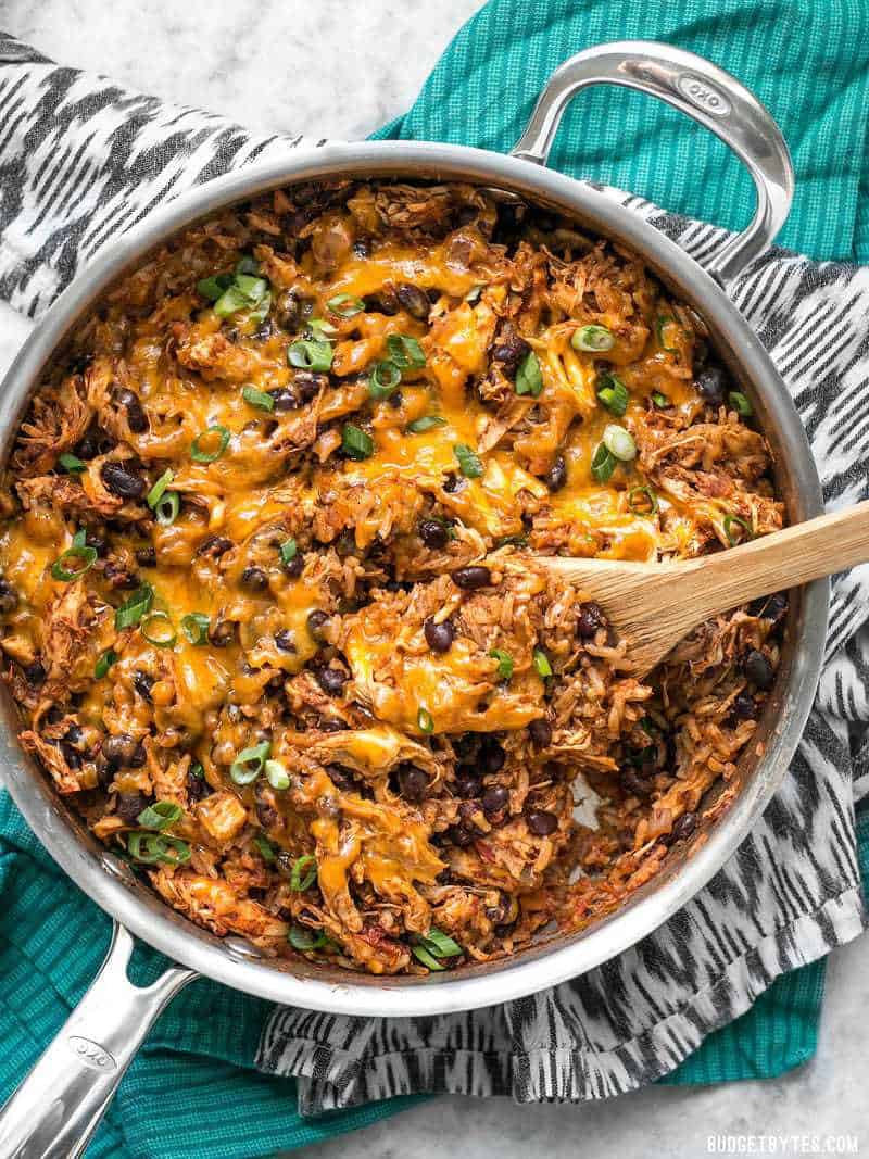 top view of southwest chicken skillet with wooden spoon