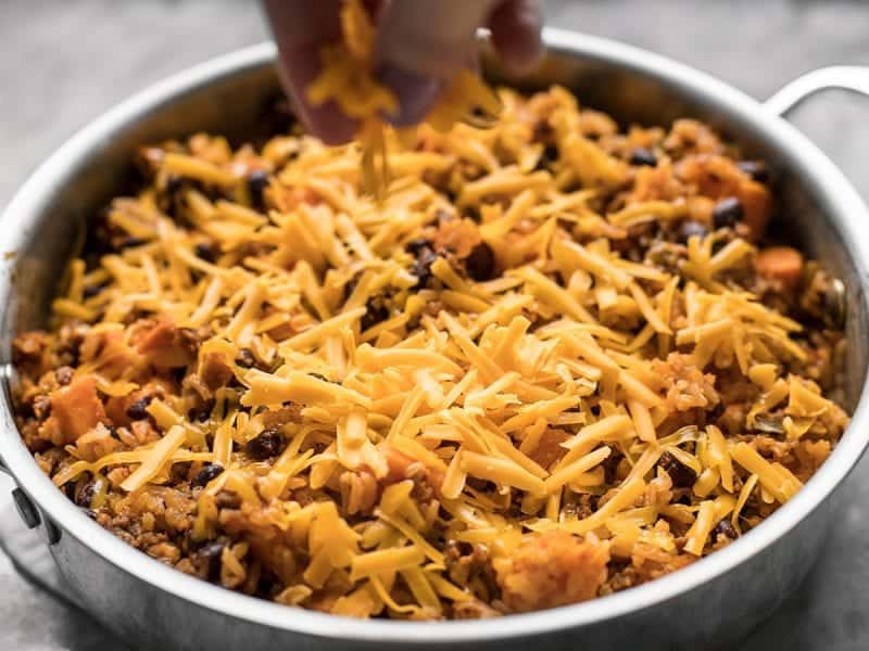 Shredded cheese sprinkled on top of Chorizo Sweet Potato Skillet