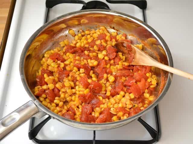 Frozen corn added to skillet 