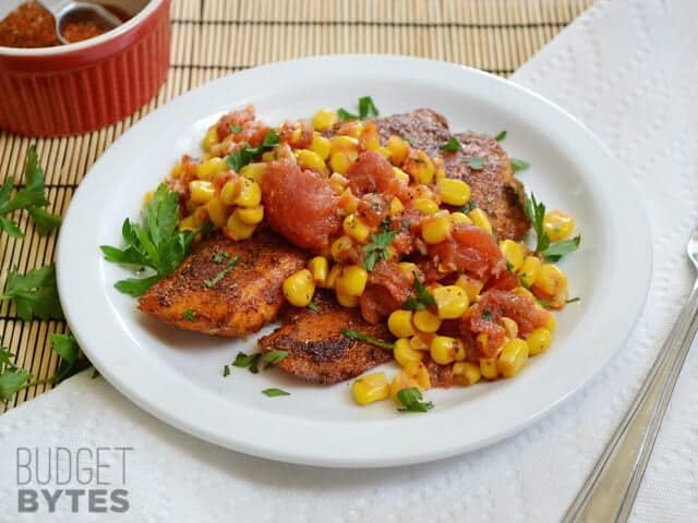 Plate of Blackened Tilapia topped with corn salad 