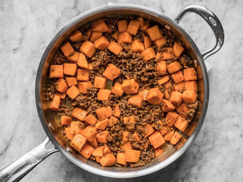 Browned Chorizo and sweet potatoes in skillet 