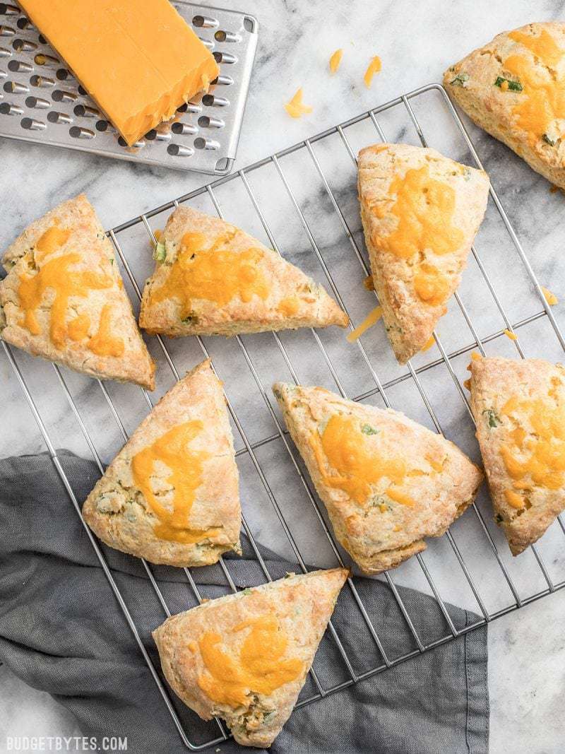 Top view of cheddar scallion scones on a cooling rack