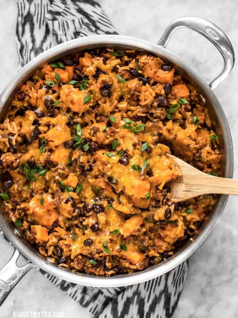 Top view of chorizo sweet potato skillet with wooden spoon 