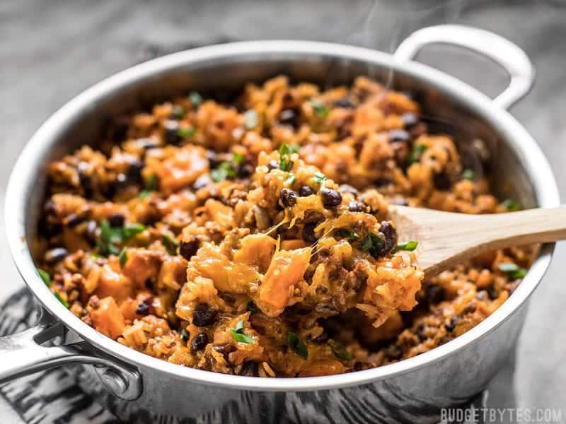 Spoonful of chorizo sweet potato skillet being scooped out