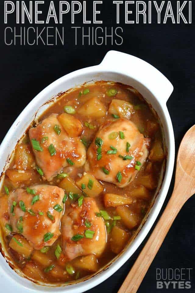 Pineapple Teriyaki Chicken Thighs in casserole dish, wooden spoon on the side 