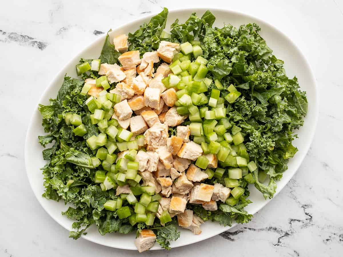 Kale salad topped with chicken and celery