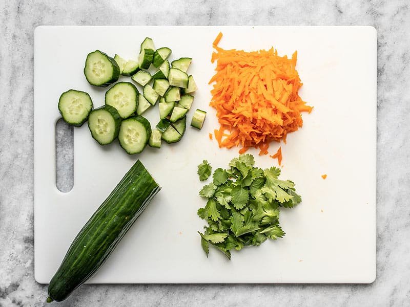 Prepped Vegetables for Spicy Tuna Guacamole Bowls on the cutting board