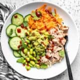 Overhead view of a Spicy Tuna Guacamole bowl with a black fork stuck in the side.