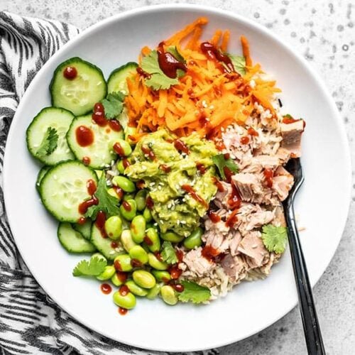 Overhead view of a Spicy Tuna Guacamole bowl with a black fork stuck in the side.