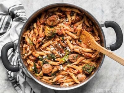 This super easy and satisfying, "sweep the kitchen" Penne Pasta with Sausage and Greens is an entire meal in one pot. Cook once, eat all week.