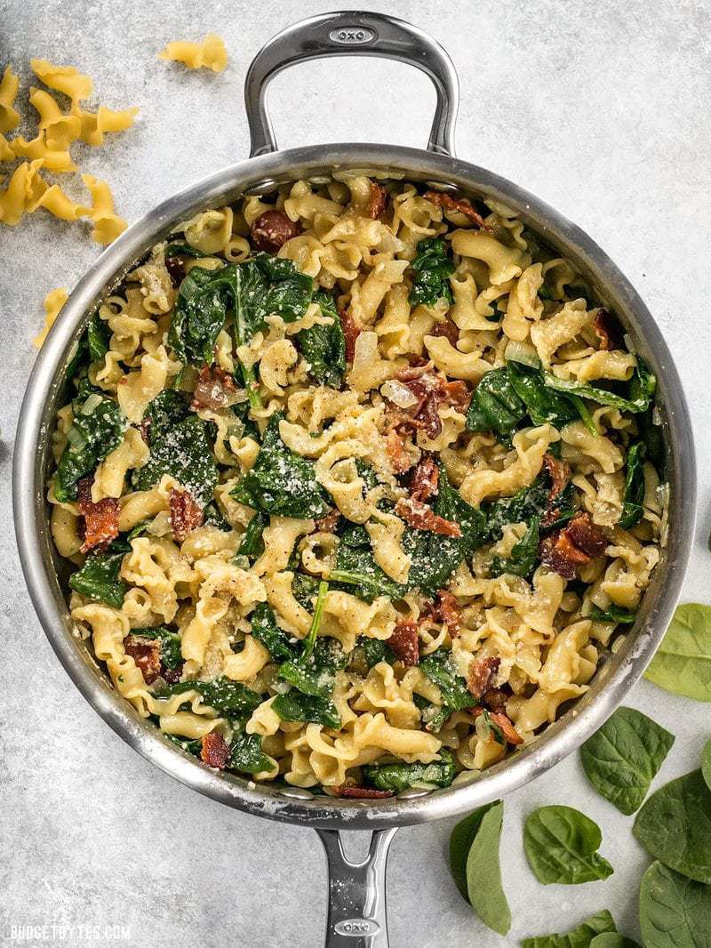 Top view of a skillet of Bacon and Spinach Pasta with Parmesan