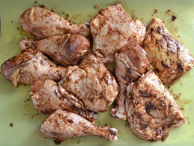 Seasoned raw chicken on cutting board 