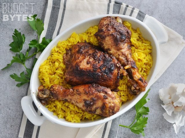 Top view of a bowl of Slow Cooker 5 Spice Chicken over a bed of rice, napkin and cilantro on side for staging 