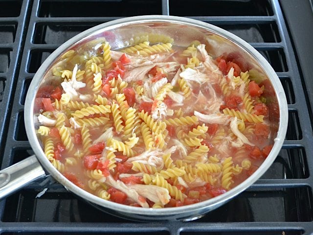 Chicken broth added to skillet with other ingredients 