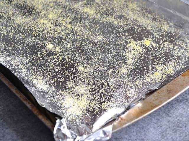 Baking sheet lined with tin foil, sprayed with non stick spray and sprinkled with cornmeal 