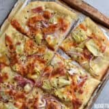 Sliced spicy Italian flatbread on a tray.