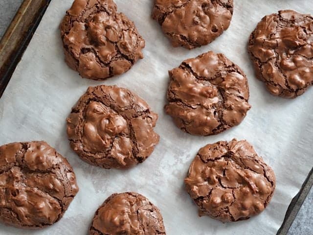 Baked Chocolate Crinkles on baking sheet lined with parchment paper 