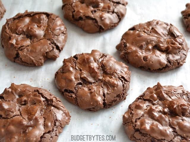 Close up of Chocolate Cayenne Crinkles on baking sheet lined with parchment paper 