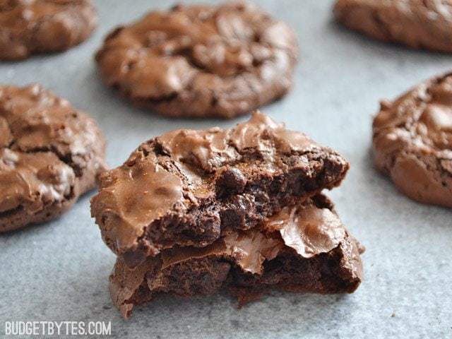 Close up of Chocolate Cayenne Crinkles broken in half, with whole cookies in the background 