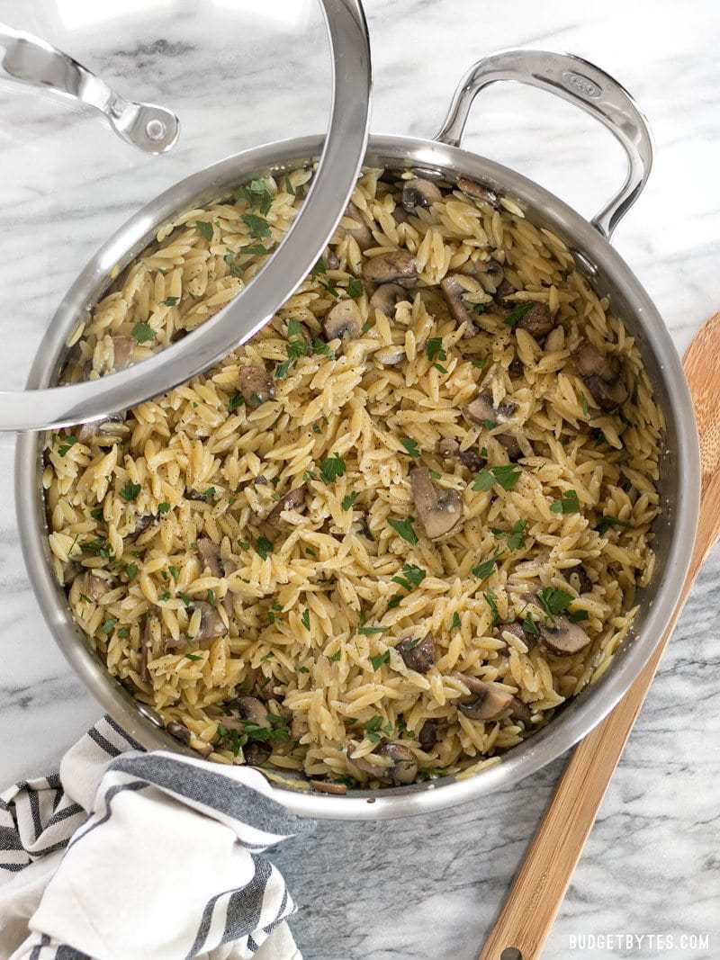 A skillet full of Parmesan Portobello Orzo just off the stove top