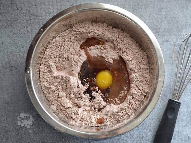 Wet Ingredients added to dry ingredients in mixing bowl, whisk on the side 