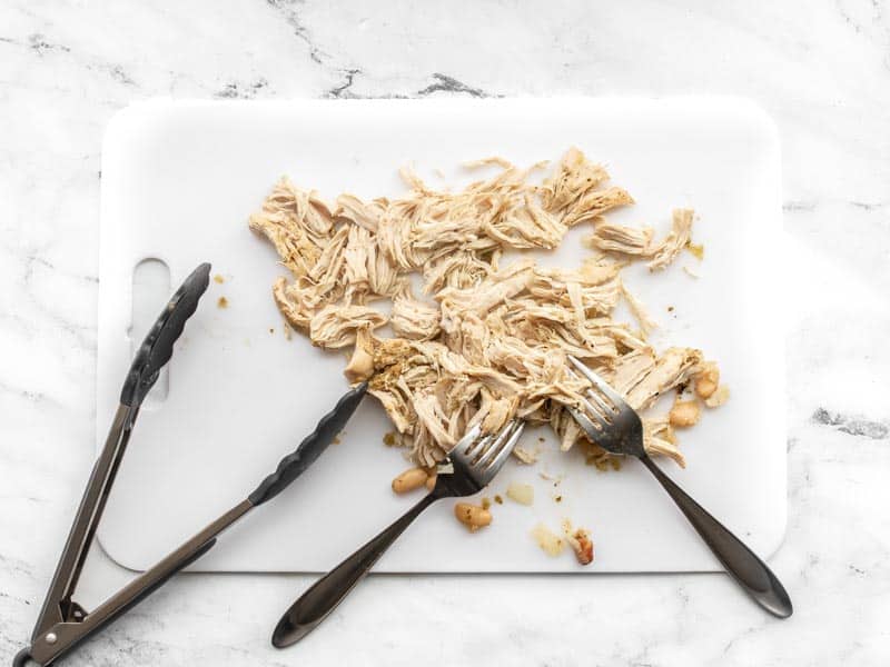 Shredded chicken on cutting board