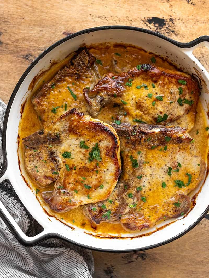 Overhead view of honey mustard pork chops in a round casserole dish