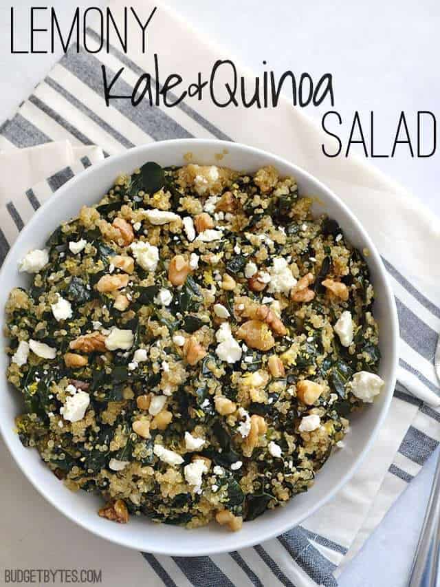 Top view of a bowl of Lemony Kale and Quinoa Salad sitting on a gray and white stripped napkin