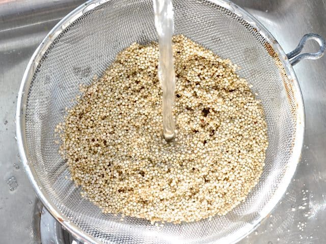 Rinsing Quinoa in strainer under water 