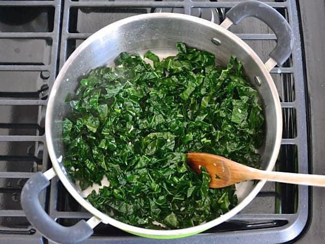 Kale added to pot to cook 