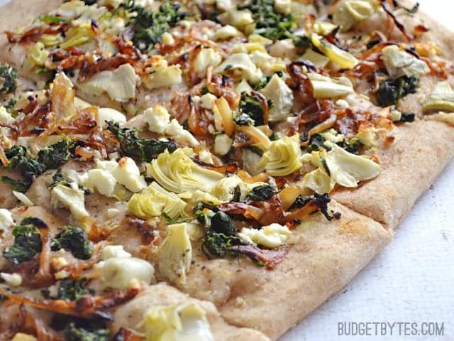 Close up of slices of Caramelized Onion and Artichoke FlatBread 
