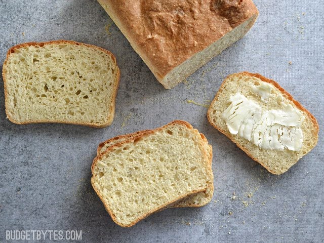 Slices of English Muffin Bread, one buttered