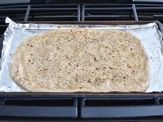 Seasoned Dough spread out on baking sheet lined with tin foil 